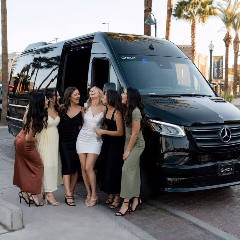 Group boarding a white charter bus for Bachelor & Bachelorette Transportation transportation in Goodyear