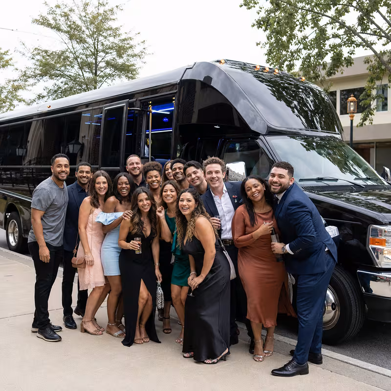Group boarding a white charter bus for Birthday Transportation transportation in Goodyear