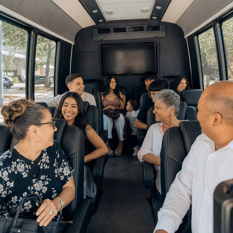 Group boarding a white charter bus for Private Event Transportation transportation in Goodyear