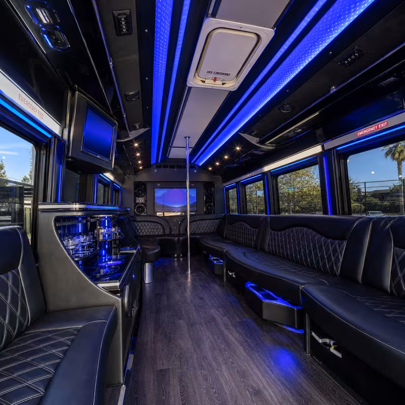 Party bus interior with wraparound leather seating and LED lighting in Goodyear