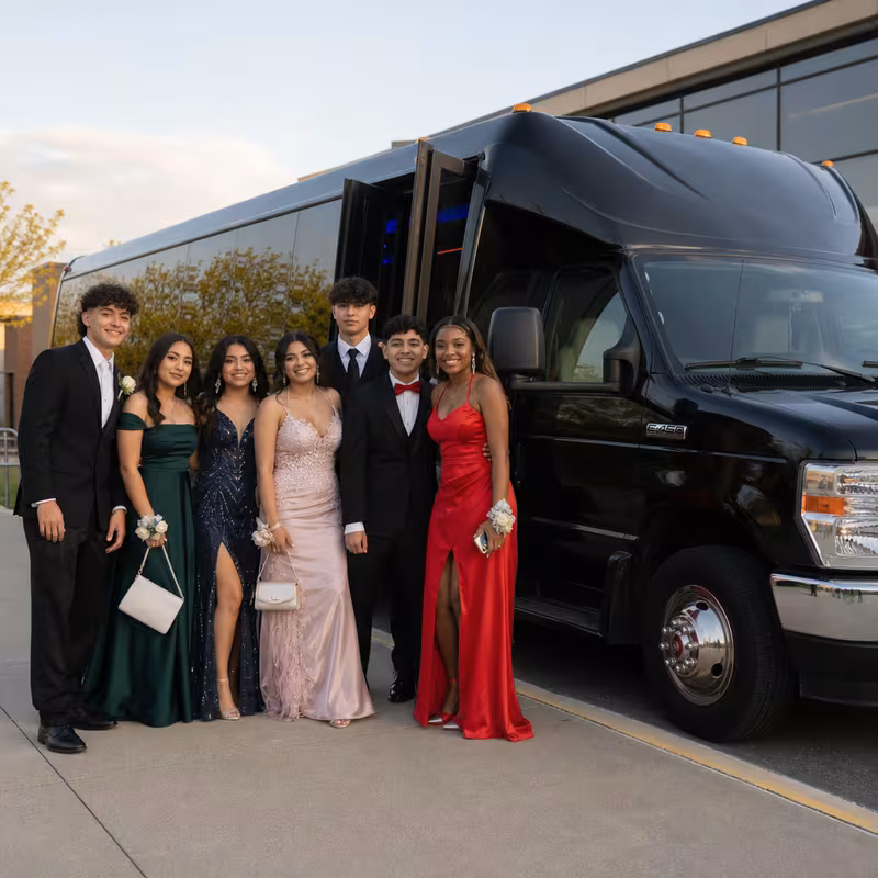 Group boarding a white charter bus for Prom & Homecoming Transportation transportation in Goodyear