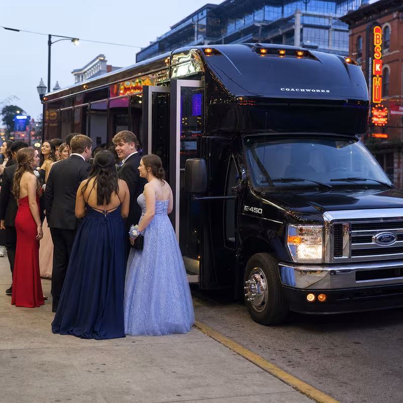 Passengers loading luggage while boarding an Goodyear group shuttle