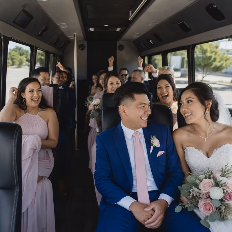 Group boarding a white charter bus for Wedding Transportation transportation in Goodyear