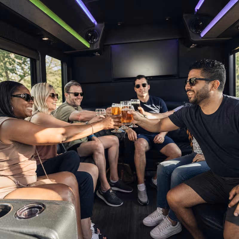 Group boarding a white charter bus for Winery & Brewery Tour Transportation transportation in Goodyear