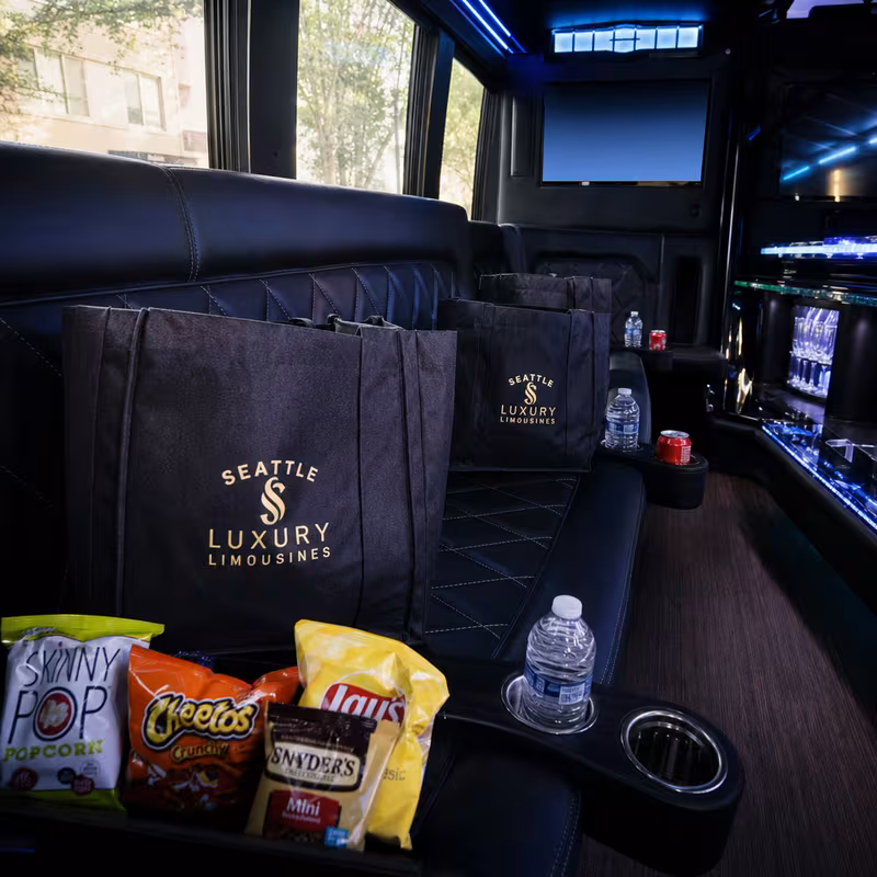 Party bus interior with wraparound leather seating and LED lighting in Goodyear